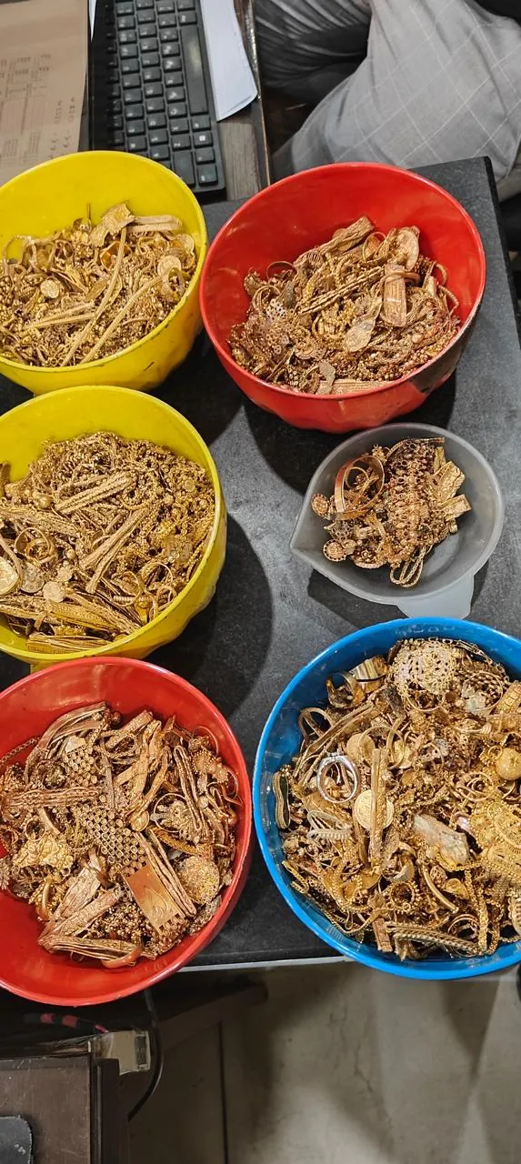 Gold items sorted by purity in bowls at Rithika Gold Hyderabad buying center