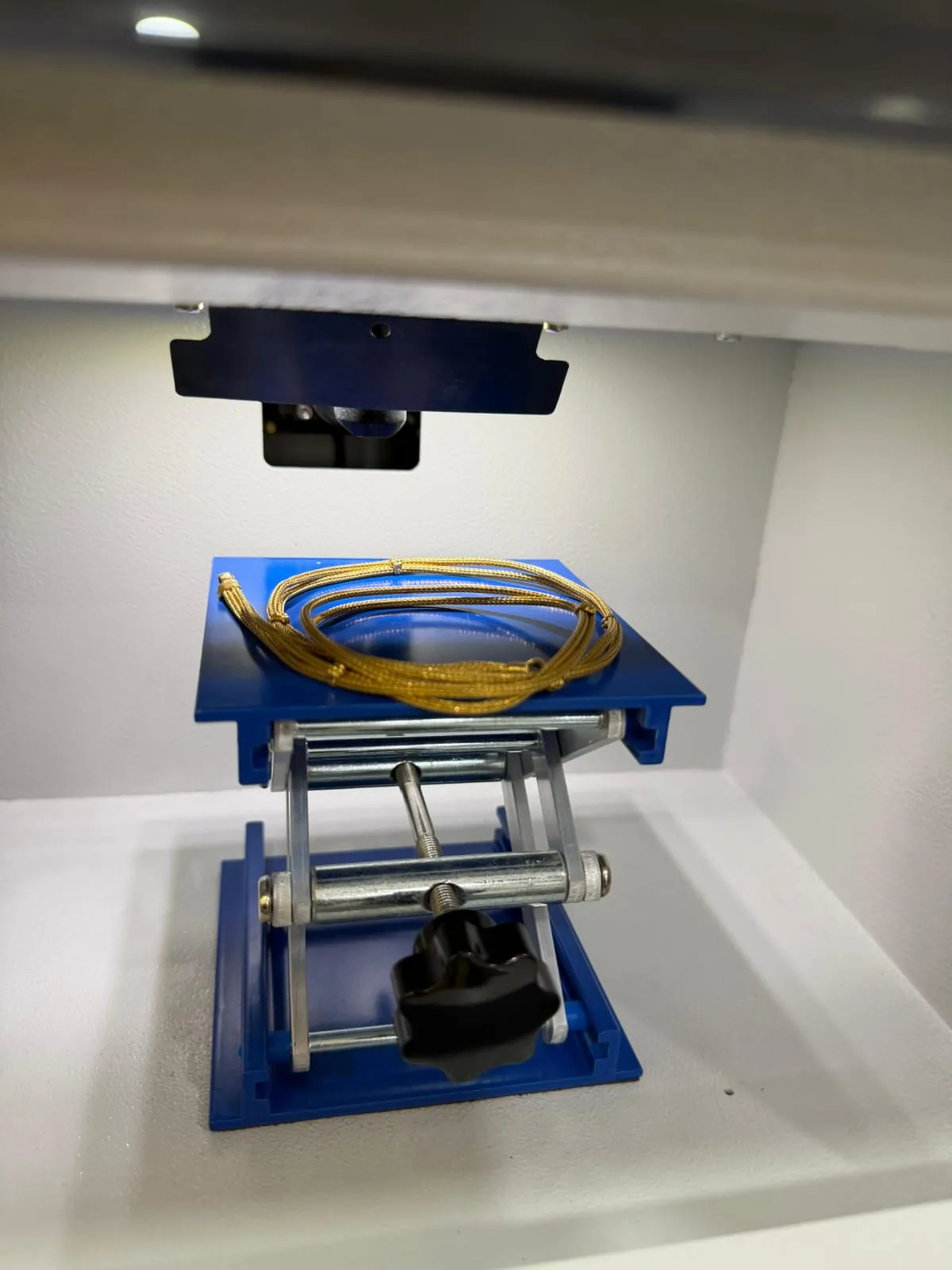 Gold chain being placed into XRF karat tester at Rithika Gold Hyderabad for purity testing
